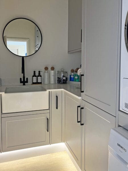 Utility space in Worcester with farmhouse sink and under-cabinet lighting by Megan Ace