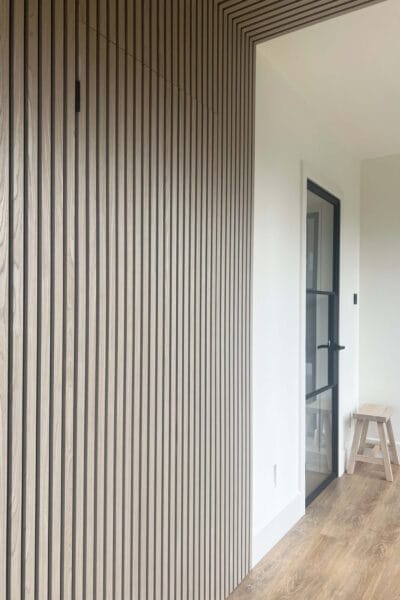 Contemporary slatted wall in hall of Worcester home renovation by Megan Ace Interiors