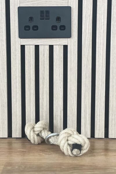 Wood slat feature wall in home gym by Megan Ace Interior Design